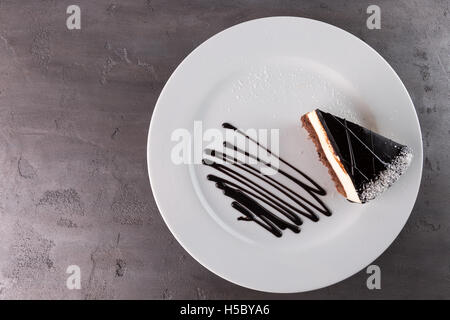 piece of chocolate cake on grey stone background. Stock Photo