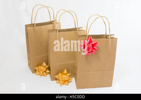 Three plain paper shopping bags with simple bows Stock Photo
