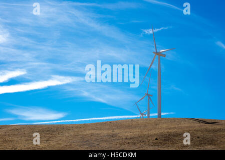 Three wind turbines on top of a hill Stock Photo
