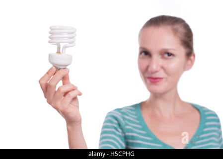 Woman showing energy saving light bulb Stock Photo