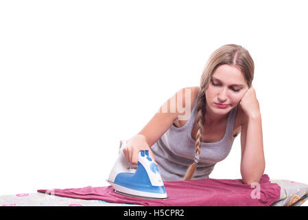 Bored sad young woman ironing clothes Stock Photo