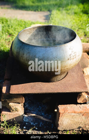 Russian fish soup cooking on the open fire Stock Photo