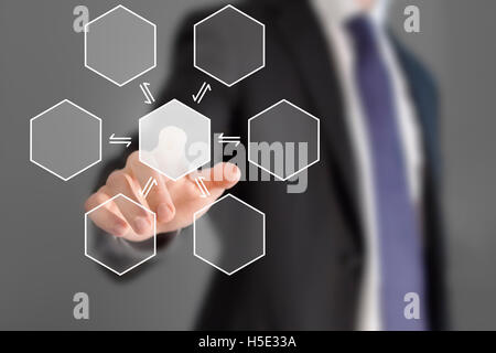 Businessman touching hexagonal button Stock Photo