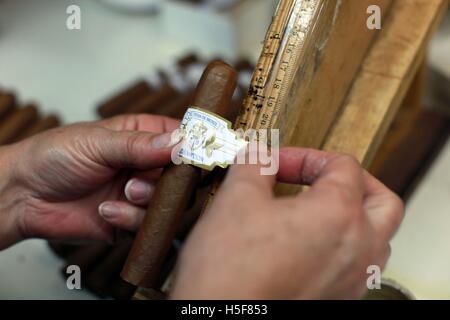 Miami, Florida, USA. 14th Jan, 2014. Cigars hand rolled at the El Credito Cigar factory in the Cuba influenced community of Little Havana. Little Havana (La Pequena Habana) is a neighborhood within the City of Miami. Home to many Cuban immigrant residents. Little Havana is noted as a center of social, cultural, and political activity in Miami, known for its landmarks, including Calle Ocho it is undoubtedly the best known neighborhood for Cuban exiles in the world, and as the cultural and political capital of Cuban Americans. Characterized by a robust street life, excellent restaurants, cultu Stock Photo