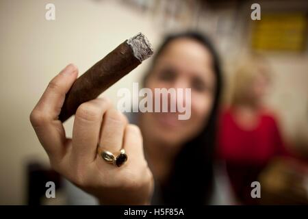 Miami, Florida, USA. 14th Jan, 2014. Cigars hand rolled at the El Credito Cigar factory in the Cuba influenced community of Little Havana. Little Havana (La Pequena Habana) is a neighborhood within the City of Miami. Home to many Cuban immigrant residents. Little Havana is noted as a center of social, cultural, and political activity in Miami, known for its landmarks, including Calle Ocho it is undoubtedly the best known neighborhood for Cuban exiles in the world, and as the cultural and political capital of Cuban Americans. Characterized by a robust street life, excellent restaurants, cultu Stock Photo