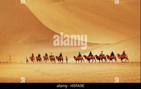 Dunhuang, Dunhuang, China. 25th Sep, 2016. Dunhuang, CHINA-September 25 2016: (EDITORIAL USE ONLY. CHINA OUT) .Tourists ride camels in the desert of Echoing-Sand Mountain in in Dunhuang, northwest China's Gansu Province, September 25, 2016. Stunning scenery of Echoing-Sand Mountain and Crescent Lake attract lots of tourists from different areas. © SIPA Asia/ZUMA Wire/Alamy Live News Stock Photo