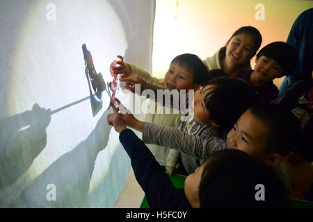 October 20, 2016 - Liaocheng, Liaocheng, China - Liaocheng,CHINA-October 20 2016: (EDITORIAL USE ONLY. CHINA OUT) ..Students of Liaocheng University perform shadow play at a kindergarten in Liaocheng, east China's Shandong Province, October 20th, 2016, promoting Chinese traditional culture.The students make ten shadow figures with recycled transparent board and pens.The students not only perform shadow play to children, but also introduce history of the intangible cultural heritage and teach them how to make shadow figures. (Credit Image: © SIPA Asia via ZUMA Wire) Stock Photo