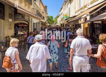 Tourists walking down a busy shop lined street in the medieval town of Aigues-Mortes, France Stock Photo