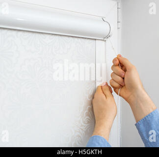 Man installing cassette roller blinds on windows. Stock Photo