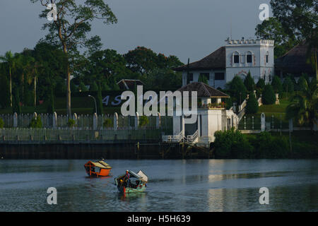 A traditional wooden boat as a mean of transportation among local to cross the river in front of the historical building ASTANA. Stock Photo