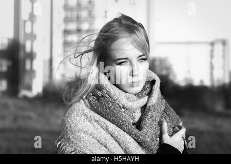 sad beautiful woman in scarf at city, monochrome image Stock Photo