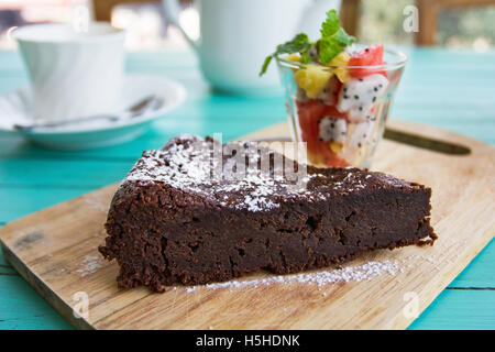 Chocolate cake with fruits salad by a cup of tea Stock Photo
