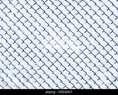 Snow covered chain link fence Stock Photo