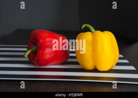 the Yellow and red peppers on a black and white striped napkin Stock Photo