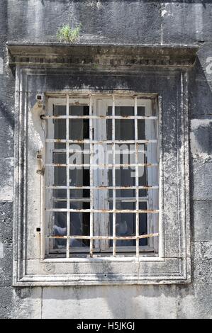 Old window with white lattice in vintage wall Stock Photo
