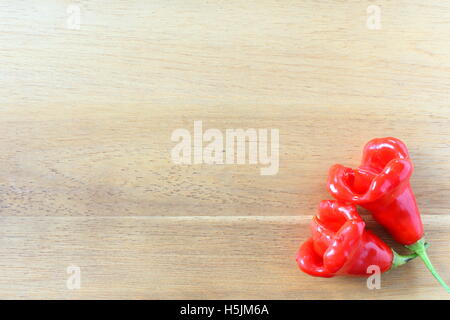 red nepalese bell chili peppers on a wooden board Stock Photo