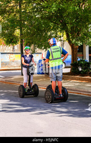 Two people on a guided segway tour around Asheville NC Stock Photo