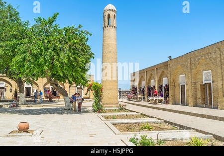 The small brick minaret in the courtyard of Dorut Tilavat complex, surrounded by the tourist market, with a lot of handmade souv Stock Photo