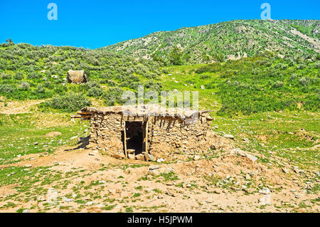 The ramshackle shed, built of stone and clay, located on the foothill of Samak kishlak (village), Uzbekistan. Stock Photo