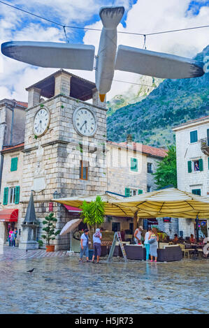 The wooden figure of the seagull suspended above the Main Square with the Kampana tower on the background Stock Photo