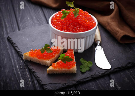 Red caviar on slate background. Selective focus Stock Photo