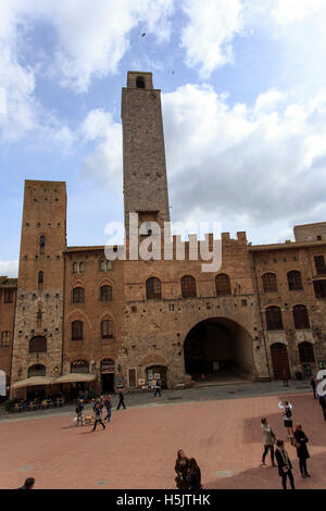 San Gimignano, Italy - April 11, 2015: historic building in san gimignano in tuscany, Italy. Tourists are walking around taking Stock Photo