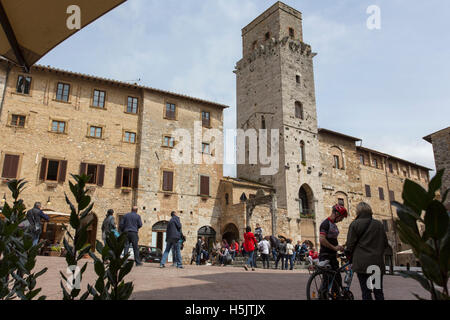 San Gimignano, Italy - April 11, 2015: historic building in san gimignano in tuscany, Italy. Tourists are walking around taking Stock Photo