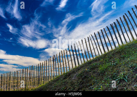 Old wooden fence on dramatic blue sky background Stock Photo