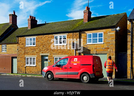 Postman deivering mail, Lyddington, Rutland, England UK Stock Photo