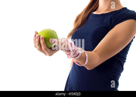 Woman's hand with centimeter around it holding an apple Stock Photo
