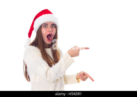 Woman in red christmas hat pointing on something Stock Photo