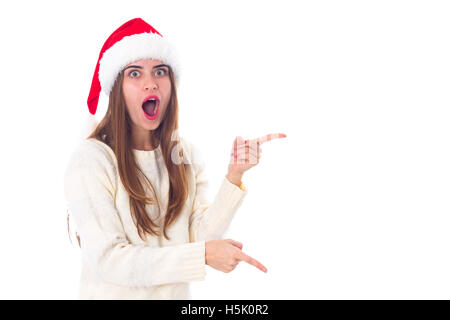 Woman in red christmas hat pointing on something Stock Photo