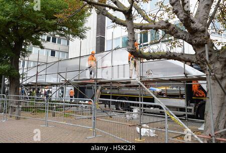 Scaffolding with sheeting is erected outside Lunar House in Croydon, south London, to offer privacy to migrants being taken off coaches as more migrants are due to arrive from the 'Jungle' camp in Calais. Stock Photo