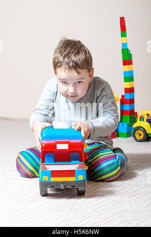 Playing little boy with colored cubes Stock Photo