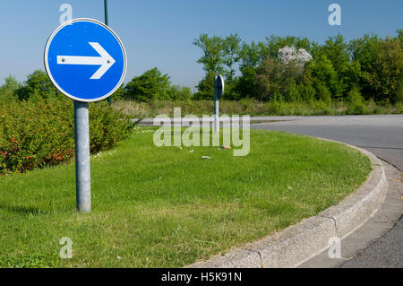 Traffic sign on roundabout indicating direction of travel, sign pointing to the right, Duesseldorf, Rhineland Stock Photo