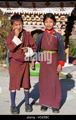 Children wearing gho and kira, national Bhutan dress for men and women, Bhutan, South Asia Stock Photo