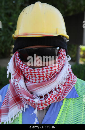 Construction worker wearing protective clothing, helmet and sunglasses, West Bay District, Doha, Qatar, Middle East Stock Photo