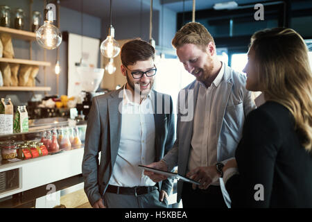 Colleagues hanging out in cafe after work Stock Photo