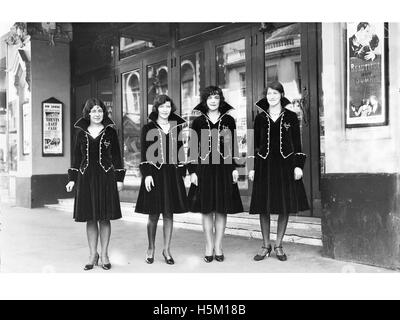 Usherettes standing in the doorway of the New Strand Theatre, Stock Photo