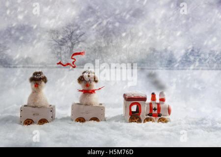 Christmas train set carrying snowmen, one with flying knitted scarf Stock Photo