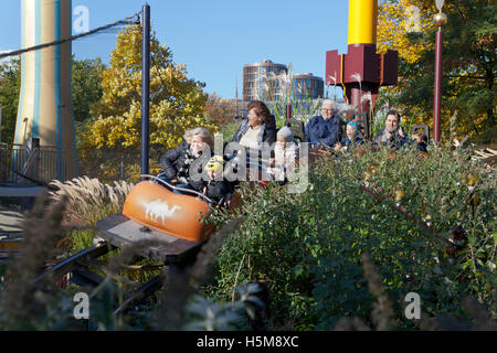 Grandmothers and grandchildren enjoy a common thrill in the Caravan ride. Tivoli Gardens, Copenhagen. Halloween theme. Stock Photo