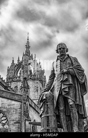 Statue of economist Adam Smith on the Royal Mile in Edinburgh, capital of Scotland with St Giles cathedral in the background. Stock Photo