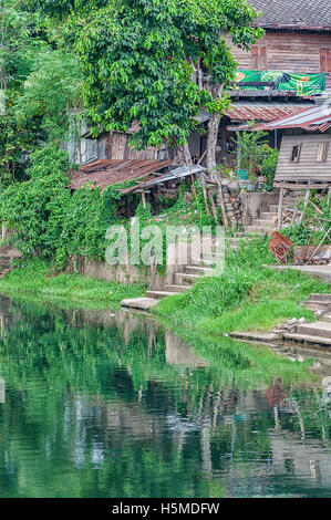 Old run down River shacks in Phetchaburi, Thailand. Stock Photo