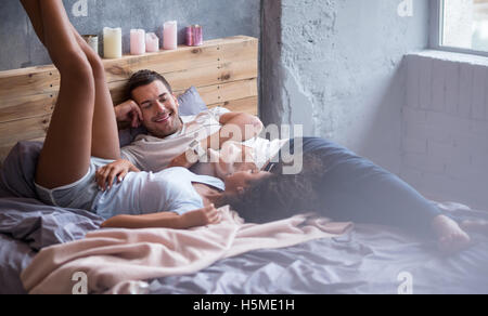 Happy couple staying in bed together Stock Photo