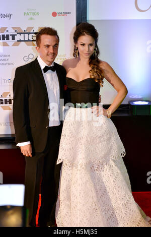 Frankie Muniz and Elycia Marie Turnbow (R) attend the 2015 Celebrity Fight Night red carpet at JW Marriott Desert Ridge Resort and Spa Stock Photo