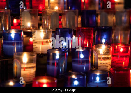 Votive candles lit in a church Stock Photo