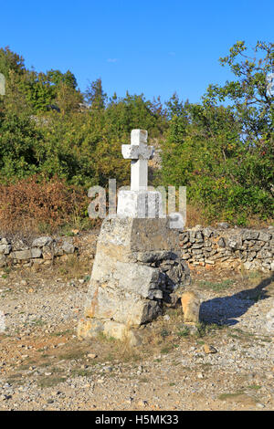 Small crucifix on a stone pillar near the St Rock Lookout and Napoleonic Road, Velo Grablje, Hvar Island, Croatia, Dalmatia, Europe. Stock Photo