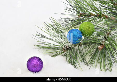 Christmas tree balls with fir sprigs on snow background, close up, space for text, horizontal, full frame Stock Photo