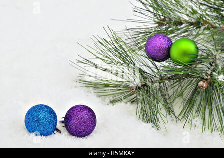 Christmas tree balls with fir sprigs on snow background, close up, space for text, horizontal, full frame Stock Photo