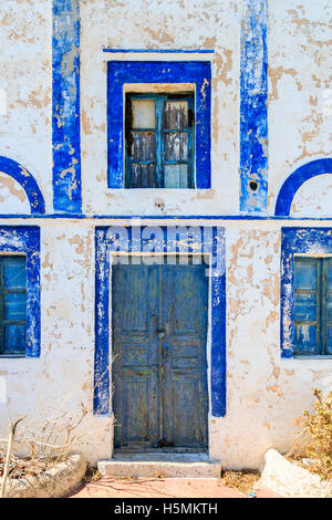 Blue wooden door and window with peeling paint in the village of Manolas on the island of Thirassia, Santorini Stock Photo
